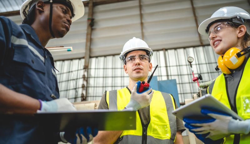 professional technician engineer team working industrial manufacturing factory, machinery production Testing new automation innovation tool for smart industrial, Professional robotic engineers specialist maintenance and control robot arm in factory warehouse, technician teamwork working together